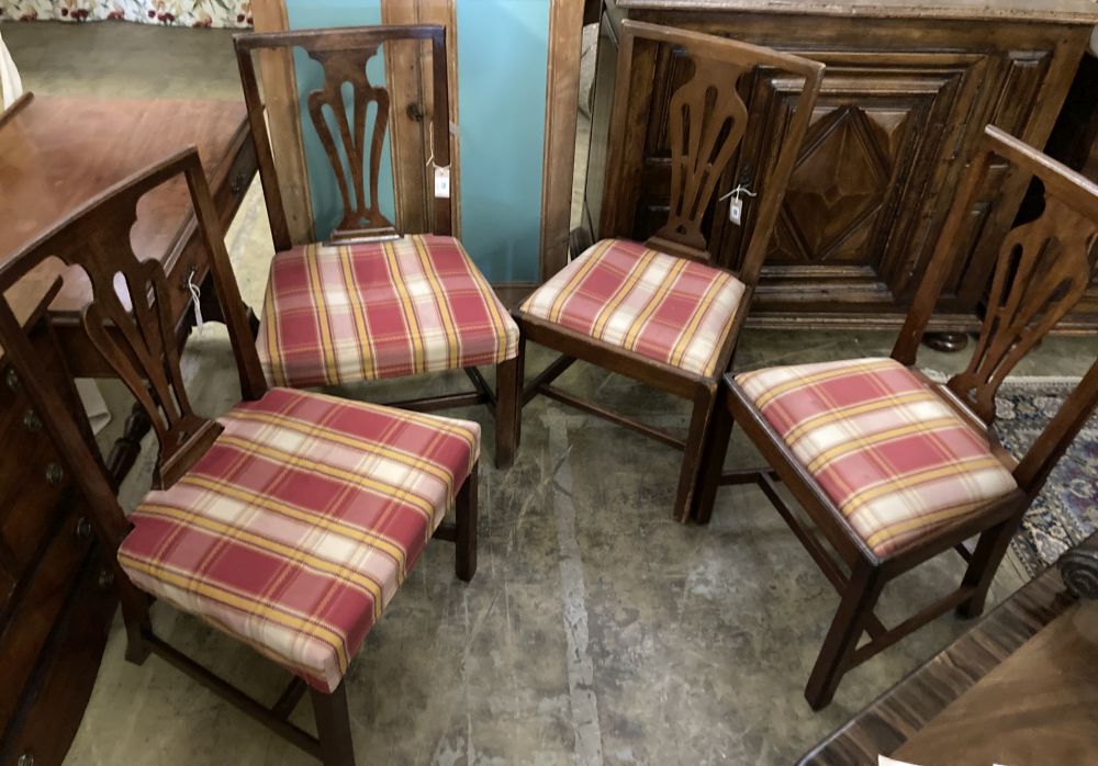 A set of four George III country Chippendale mahogany dining chairs,